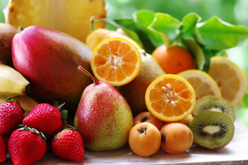 Fototapeta na wymiar strawberry, loquats, mango, pears and sliced citric fruits