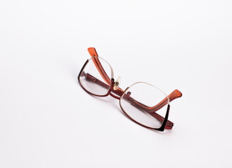 Reading glasses on a white surface.