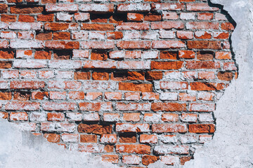 Old brick wall and white plaster. Vintage background with old brick wall. Collapsing wall.