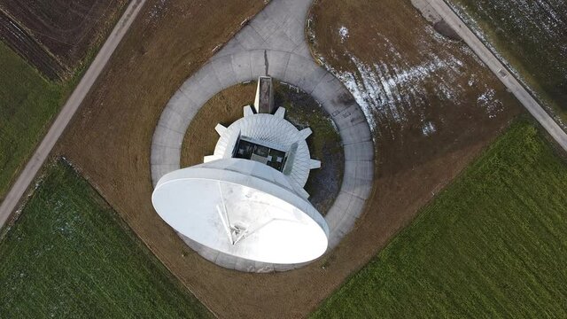 Raisting, Germany Bavaria - December 12, 2020: Large white radio telescope satellite communications parabolic dish called the Erdfunkstelle Radom built in the 1960s near Munich and the Alps.