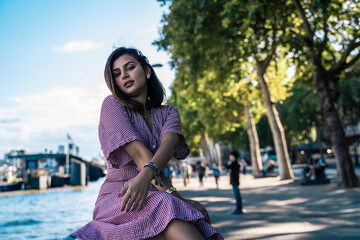 Portrait of a beautiful young woman outdoors in the city. Urban landscape. Travel and freelance lifestyle. Youth and beauty
