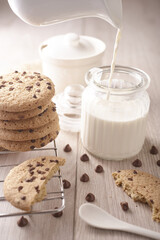 breakfast of freshly baked chocolate chip cookies on a metal rack with fresh milk for hunting