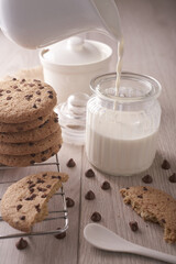 breakfast of freshly baked chocolate chip cookies on a metal rack with fresh milk for hunting