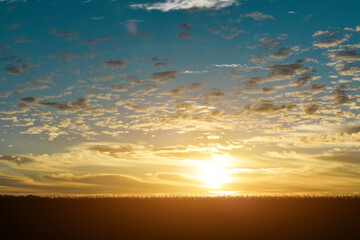 Natural sunset or sunrise over field meadow. Countryside Landscape.