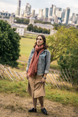 Portrait of a beautiful young woman outdoors in the city. Urban landscape. Travel and freelance lifestyle. Youth and beauty