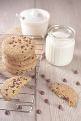 breakfast of freshly baked chocolate chip cookies on a metal rack with fresh milk for hunting