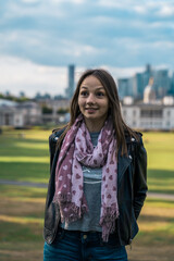 Portrait of a beautiful young woman outdoors in the city. Urban landscape. Travel and freelance lifestyle. Youth and beauty