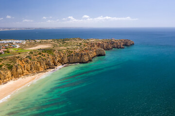 Obraz premium Ponta da Piedade and Canavial Beach. Portuguese southern golden coast cliffs. Aerial view over city of Lagos in Algarve, Portugal.