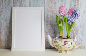 Blooming hyacinths and picture frame with copy space for mockup