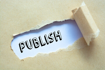 Text Publish appearing behind ripped brown paper.