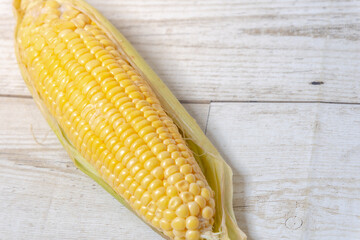 Corn on wooden floor, Yellow corn on the wood floor, organic ripe corn on wooden floor of a cottage background.