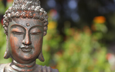 Buddha Statue in Outdoor Garden With Blurred Background