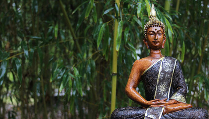 Buddha Statue in rain with bamboo background
