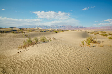 Mesquite Flat Sand Dunes in Death Valley National Park, and beautiful cloudy sky on background