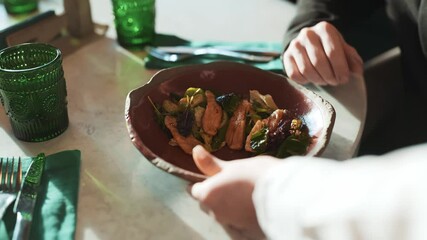 Cafe scene of waitress bringing order to table with business coworkers. Mask wearing girl putting dish on table. Colleagues discussing work, talking about current situation. Concept of coronavirus