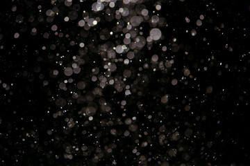 Black bokeh texture on black background