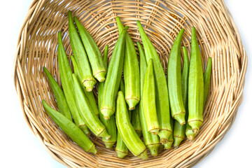 Fresh organic okra in wooden basket