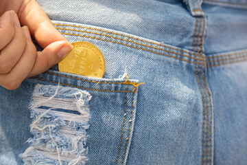 A closeup of a woman putting bitcoin cryptocurrency coin
