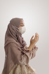 Young Muslim woman praying with Hand praying gesture isolated white background background
