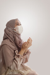 Aasean Muslim woman praying with Hand praying gesture isolated white background background