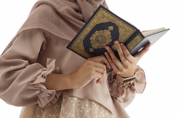 close up hand holding a holy Qur'an