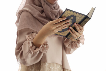 close up hand holding a holy Qur'an