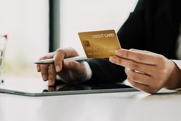 Close up woman hand using credit card and tablet for buying online shopping at home ,payment,buying and online shopping concept.