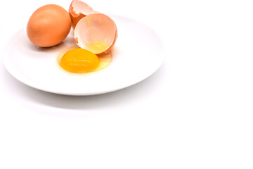 Fresh farm brown Chicken Egg.Separated egg white and yolk on a white plate isolated on white background