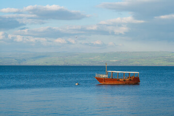 Boat on the sea of galilee, Lake Tiberias, Kinneret, in israel - obrazy, fototapety, plakaty