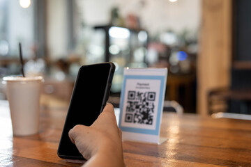 Men use phones to scan a qr code to select a menu or scan to receive a discount or pay for food and...