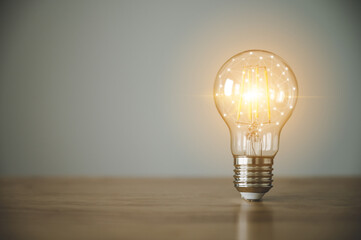 Light bulb on wood table with copy space. Concept of inspiration creative idea thinking and future...