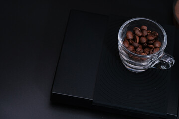 Hand driper of Prepare drip coffee on digital scale in Studio dark tone.