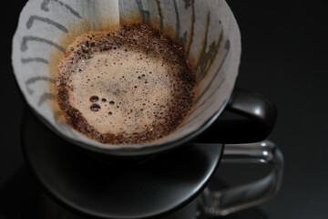 Hand driper of Prepare drip coffee on digital scale in Studio dark tone.