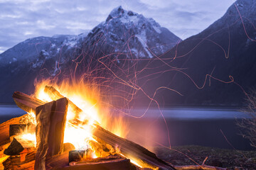 Fireside camping by mountain lake