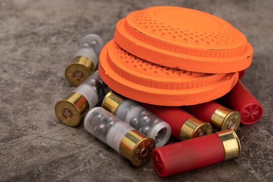 Clay disc flying targets and shotgun shells on texture background ,Clay Pigeon target game