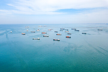 Aerial view from drone, Oil tanker ships off the coast in beautiful peaceful environment,...