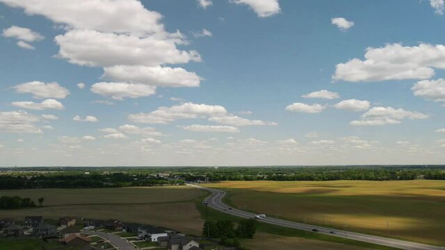 Time lapse of water tower, blue skies, and white fluffy clouds