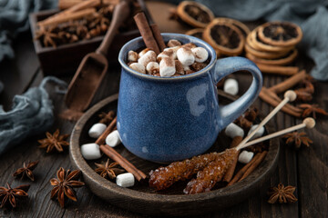 Mug with hot chocolate and marshmallows on wooden table