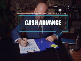  CASH ADVANCE inscription on the screen. male inspecting market data. A cash advance is a short-term loan from a bank or an alternative lender.