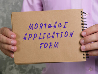 Business concept meaning MORTGAGE APPLICATION FORM with phrase on the sheet.
