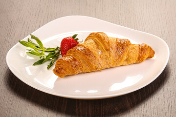 Sweet croissant in the plate
