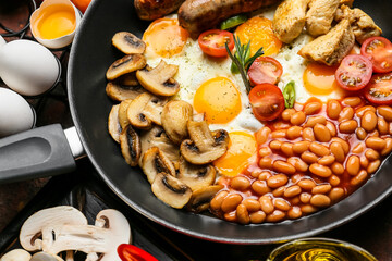 Frying pan with tasty breakfast on table