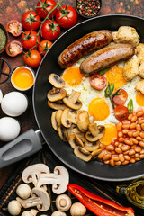 Frying pan with tasty breakfast on color background