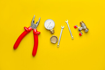 Set of plumber's items on color background