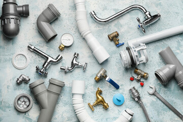 Set of plumber's items on color background