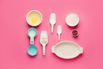 Fototapeta na wymiar Ingredients for preparing bakery and kitchen utensils on color background