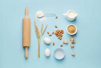 Ingredients for preparing bakery and kitchen utensils on color background