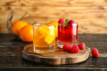 Glasses of tasty jelly on dark wooden background