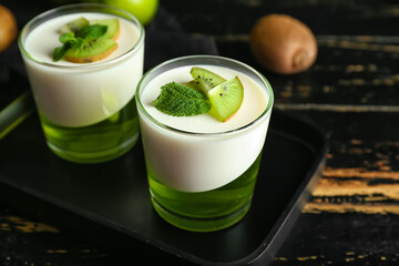 Glasses of tasty jelly on dark wooden background