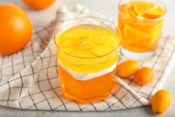Glasses of tasty jelly on light background